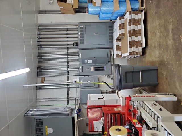 An electrician works on a commercial electrical system.