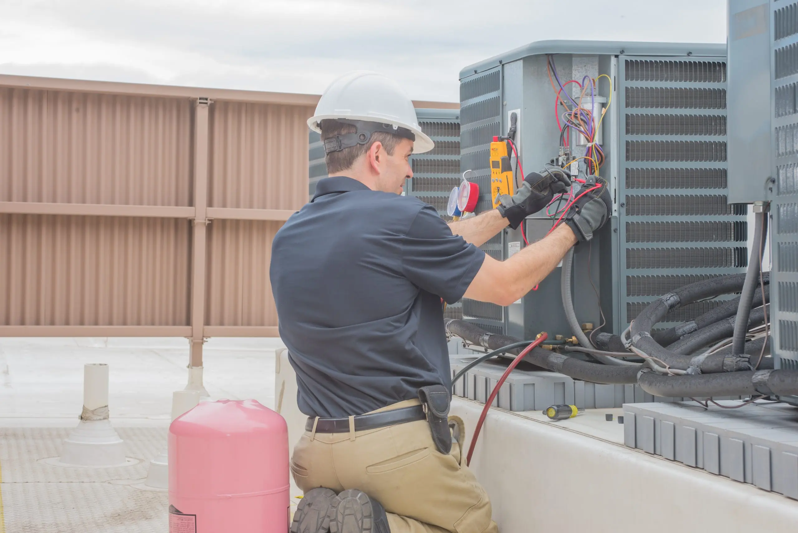 Electrician using a digital meter to test commercial electrical panel