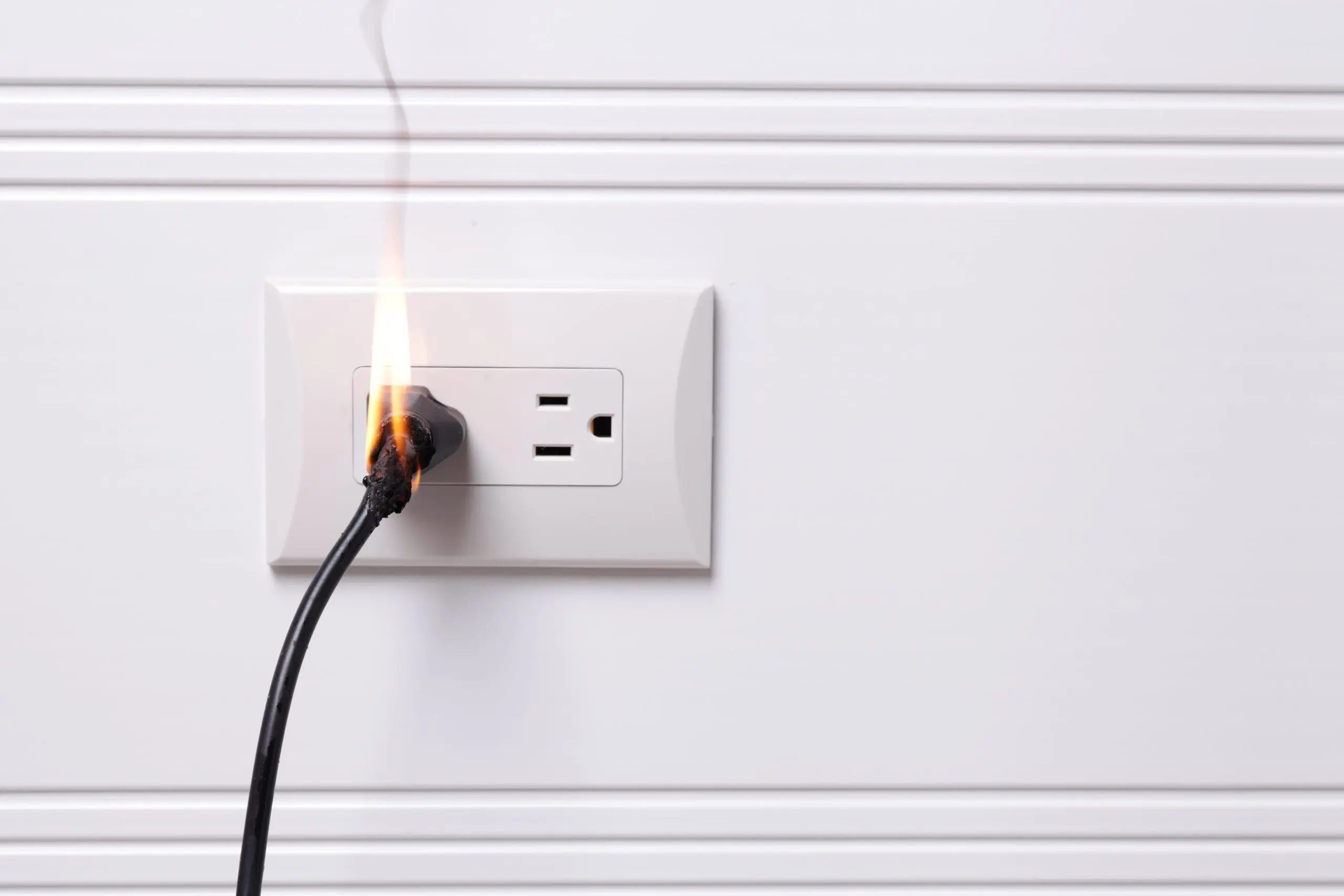 Electrical cord catching fire in wall outlet